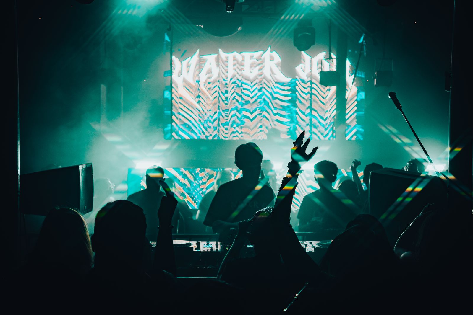 Crowd in silhouette under the screens